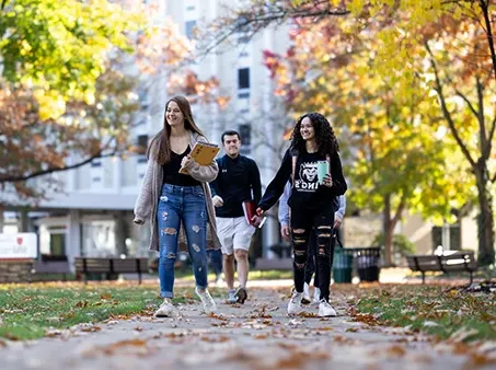students walking outdoors in fall weather